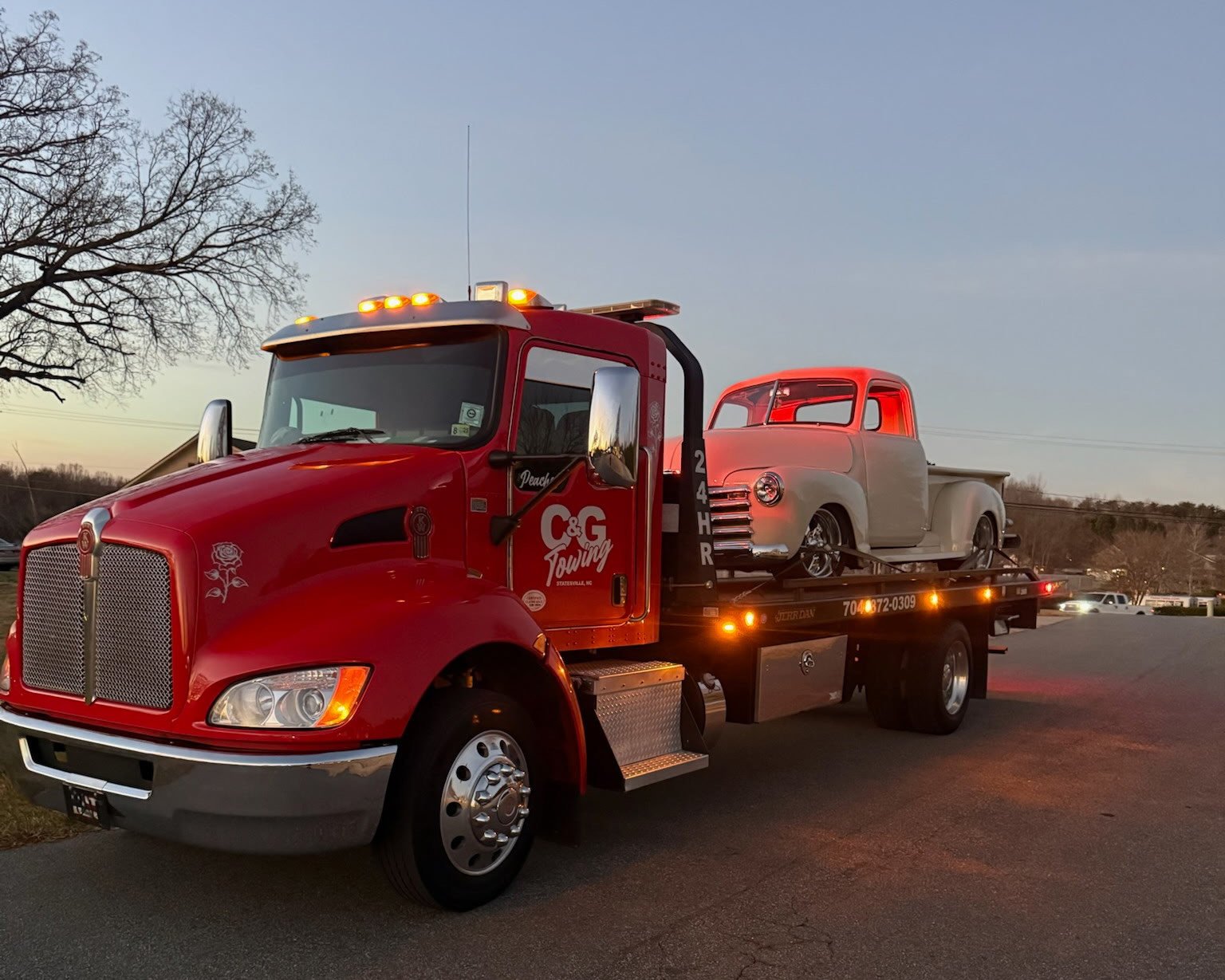 C and G Towing flatbed tow truck at dusk
